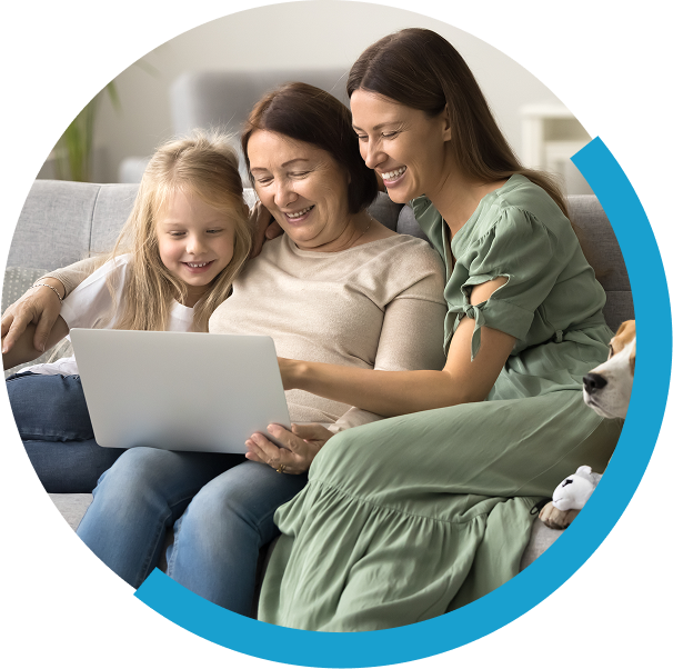 three girls on couch looking at computer