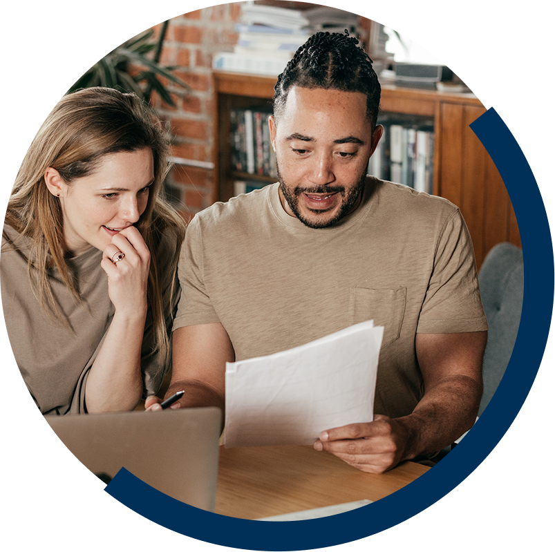 man and woman looking at paper