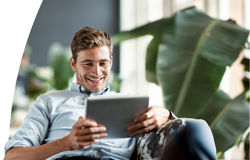 Man on his couch with tablet
